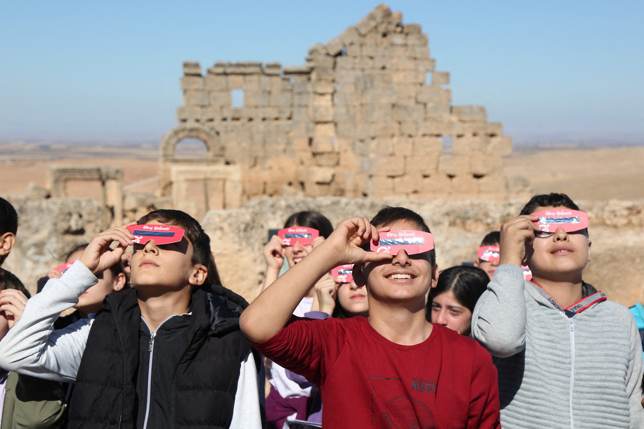 People watch a partial solar eclipse in Diyarbakir, Turkey. <a>Sertac Kayar/Reuters</a>