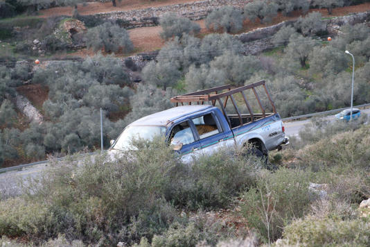 The truck in which Tawfic Hafeth Abdel Jabbar was shot dead sits over Highway 60 in the occupied West Bank on Saturday. (Chantal Da Silva)