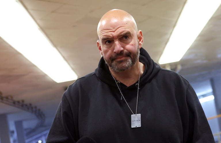 U.S. Sen. John Fetterman (D-PA) speaks to reporters before a Senate luncheon at the U.S. Capitol on December 12, 2023 in Washington, DC. The former progressive has gained some support and also had some detractors due to his recent commentary on the Middle East and the influx of migrants crossing at the U.S.-Mexico border.
