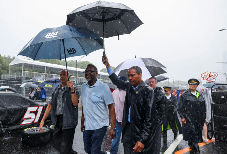 Mayor Brandon Johnson walks through pit road on Columbus Drive while the NASCAR Cup Series is delayed due to rain in Grant Park on July 2, 2023.
