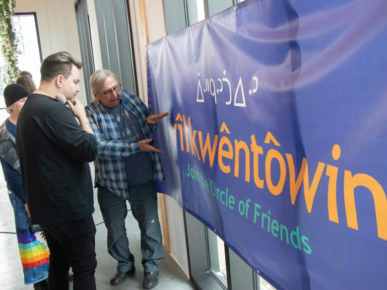 The Oliver community in central Edmonton unveiled its proposed new Cree name Wîhkwêntôwin, which means circle of friends, on Tuesday, Jan. 23, 2024. Mathew Ward listens to elder Jerry Saddleback explain the name on a banner. 