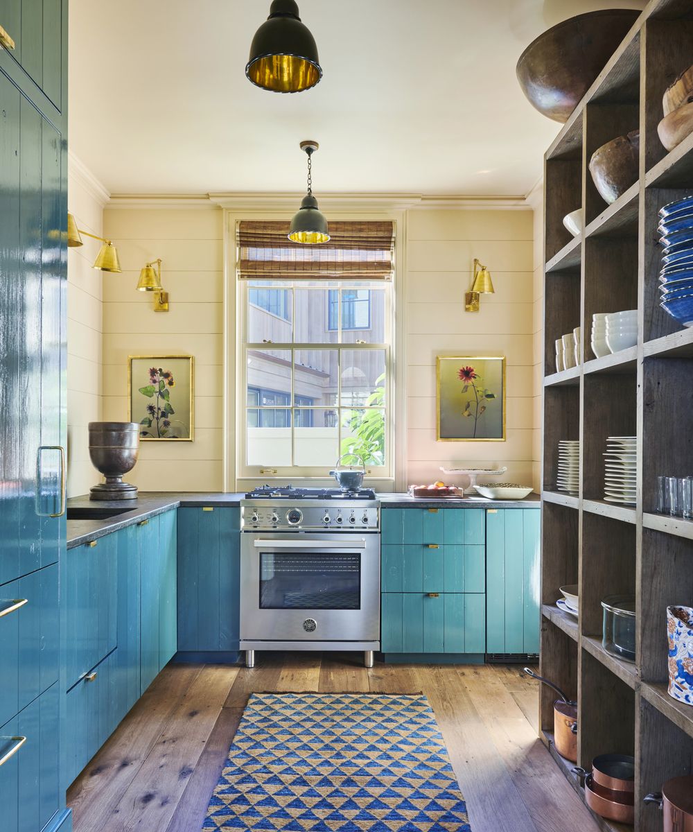 <p>Gil Schafer and the late Suzanne Rheinstein channeled the blue of the nearby sea in the paneled cabinets of the casual kitchen of <a href="https://www.veranda.com/decorating-ideas/house-tours/a43983919/rheinstein-schafer-newport-beach-house/">this Newport Beach home</a>.</p>