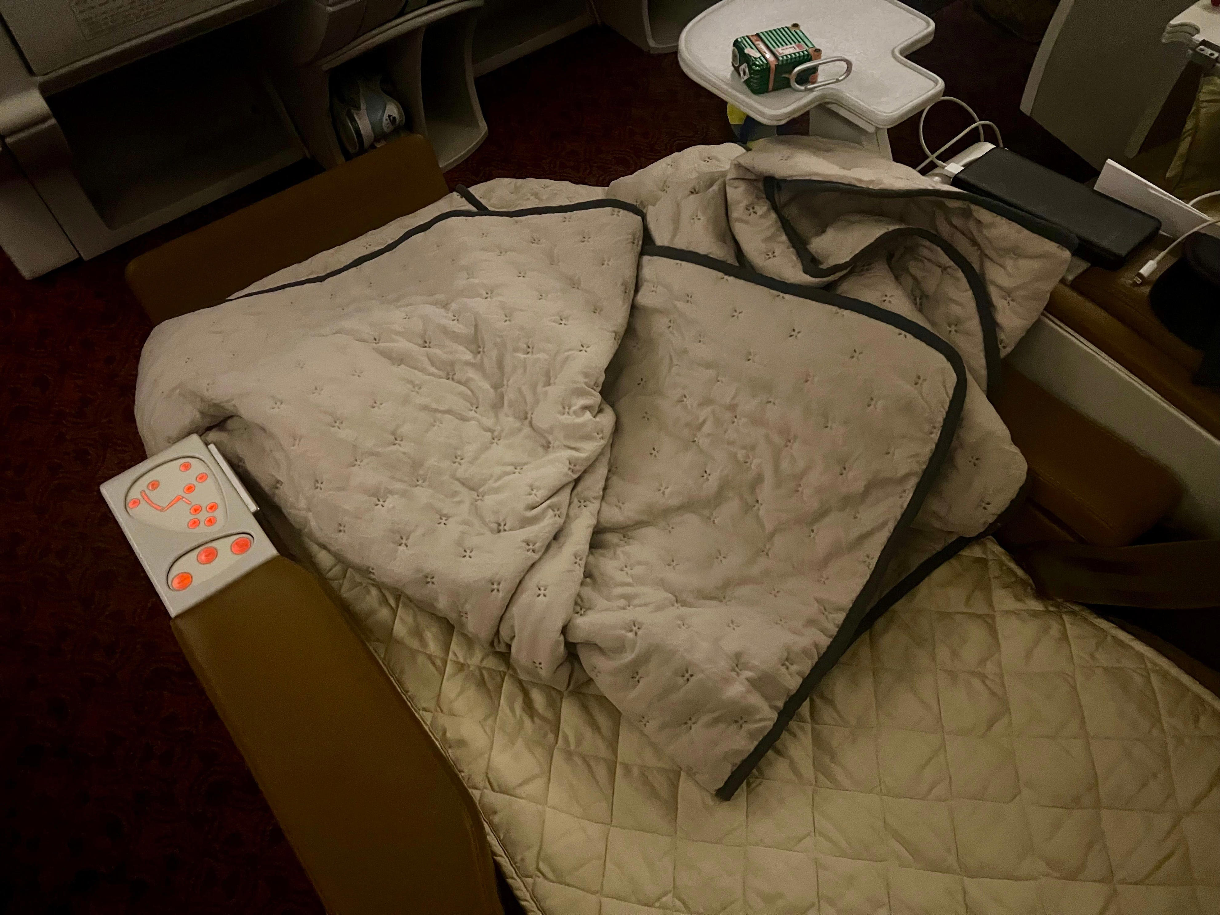 <p>The beds do not fully stretch to the TV, so the middle or window seat passenger could step over the aisle without disturbing them — if they're careful, anyway.</p><p>Still, this isn't an ideal setup and something Air India is addressing with its $400 million refurbishment project.</p>