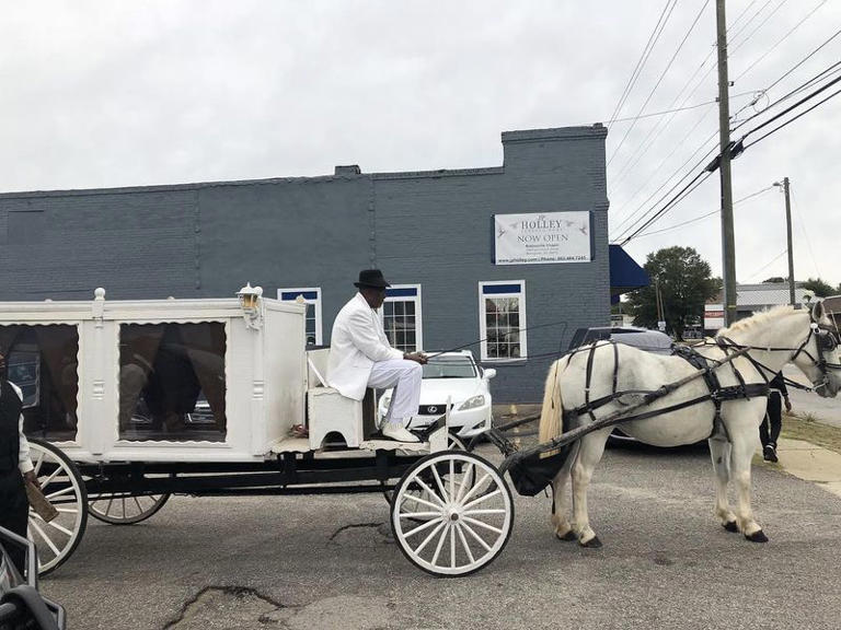 A horse-drawn hearse at the JP Holley Funeral Home.