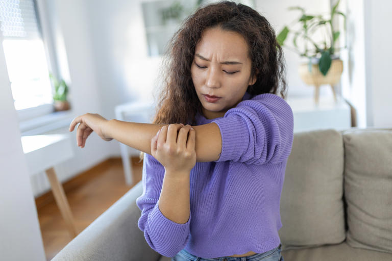 Stock image of a woman experiencing joint pain. An orthopedic from Miami explains how to avoid joint pain with exercise. Getty Images