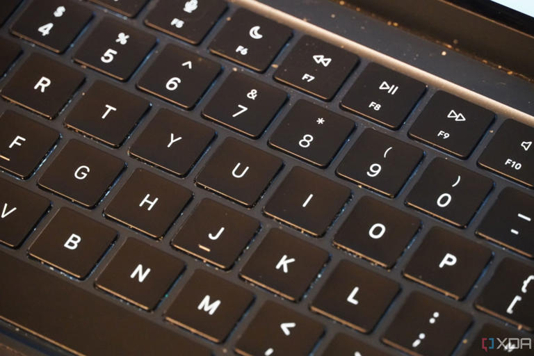 The surface of a dirty laptop keyboard.