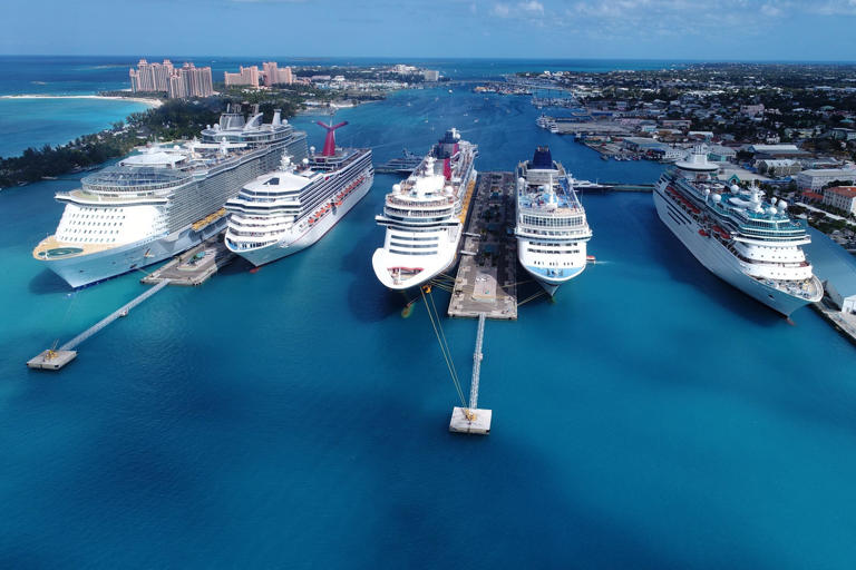 High Angle View Of Cruise Ships Moored In Sea Against Blue Sky