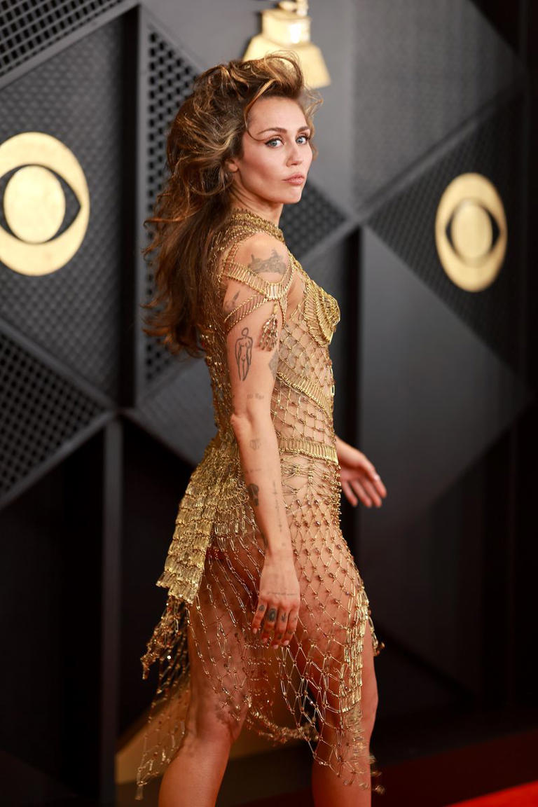 Miley Cyrus Wore A Completely Sheer, Gold Netted Dress To The 2024 Grammys