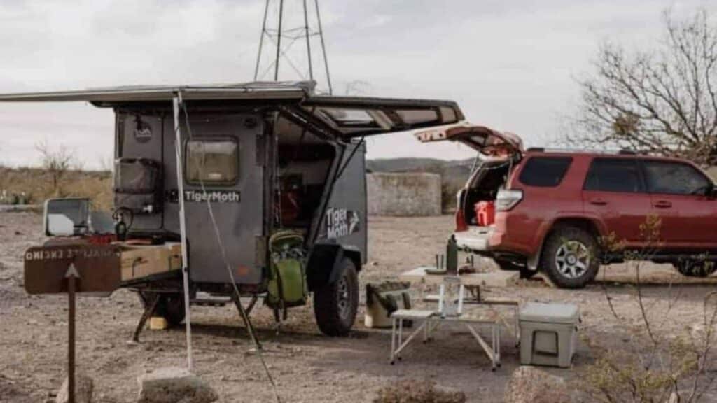 <p><strong>Looking for an adventure micro camper?</strong> The rugged TigerMoth Overland from TAXA Outdoors can take you off-grid for seven days or more. This cool trailer has a distinctive look, lots of cleverly hidden amenities, and plenty of storage for your gear.</p><p>What makes the TigerMoth stand out is the huge side hatch, which offers amazing views and plenty of ventilation. Inside, you’ll find a full-size bed couch with up to 12 cubic feet of storage underneath, a few cabinets, and a small table. There’s even a water tank, USB plugs, and lights.</p><p>The exterior is equipped with 16” all-terrain tires, a pull-out outdoor rear kitchen, a front cargo step, a roof cargo deck, a 4” lift for added ground clearance, and an articulating Lock ‘n Roll hitch that provides more freedom and ease than a standard ball hitch when maneuvering this trailer. </p>