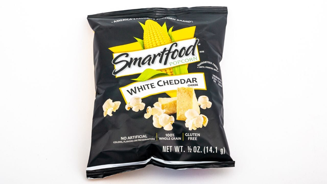 <p>Smartfood White Cheddar Popcorn is a snack that curbs appetite but leaves fingers sticky with white cheddar dust. The kernels maintain a lighter personality than other popcorn brands with more intense flavor, yet it’s difficult not to indulge in the whole bag.</p>