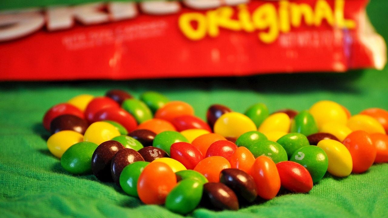<p>Taste the rainbow, Skittles’ famous slogan states. Red, orange, yellow, green, and purple morsels make up the traditional flavor, while blue hues and pink come with the tantalizing wild berry set.</p>