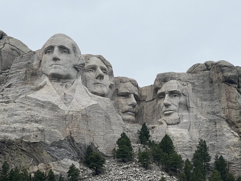 <p><span>South Dakota's most popular attraction, </span><a href="https://www.mileswithmcconkey.com/how-to-visit-mount-rushmore-what-you-need-to-know/"><span>Mount Rushmore</span></a><span>, showcases the 60-foot-tall faces of George Washington, Thomas Jefferson, Theodore Roosevelt, and Abraham Lincoln. Walk the Avenue of Flags to the aptly named Grand View Terrace. You gain unique alternative viewpoints by walking the Presidential Trail. </span></p><p><span>The Lincoln Borglum Visitor Center digs into the sculpture's history, functioning as a museum with historical artifacts and photos. Stay for the Evening Lighting Ceremony for an inspirational program and to see the memorial illuminated. Beyond the iconic landmark, the Black Hills region harbors beautiful scenery and exotic wildlife, yielding picturesque hikes and scenic drives.</span></p>