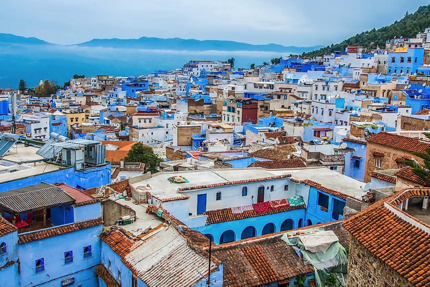 <p><span><span><span><span><span><span>Chefchaouen is a magical blue village in the heart of Morocco's Rif Mountains. Visitors say it's almost like the town is painted in various shades of blue from the palest sky at dawn to the deepest midnight. Walking through its narrow lanes, you'll feel as though you've stepped into a dream, with each corner unveiling a new azure mystery. Local craftspeople sell unique handmade goods, from woven rugs to ornate jewelry, perfect for memorable souvenirs. Sipping mint tea in the peaceful squares, you'll quickly find yourself greeted by the friendly locals who are as inviting as the town itself. Surrounded by the natural beauty of the local mountains, it's an ideal spot for hikers and photographers. Chefchaouen offers a peaceful escape from the endless hustle of city life, allowing travelers to bask in its cool, calm, and captivating atmosphere.</span></span></span></span></span></span></p>