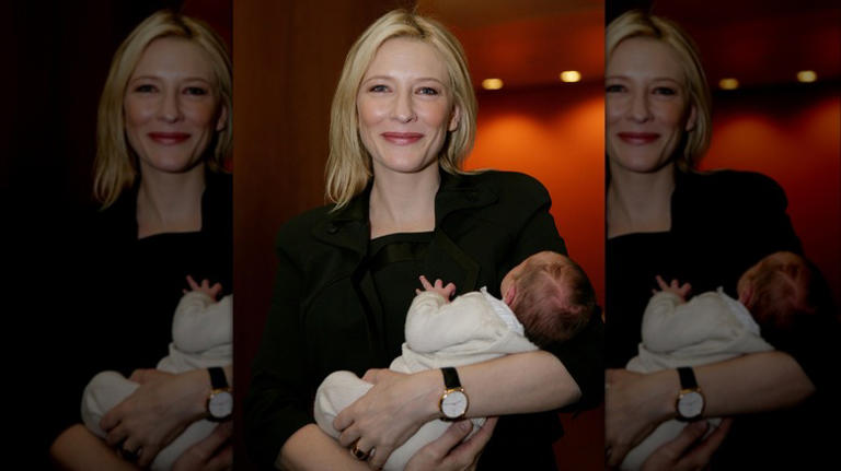 Cate Blanchett holding her son