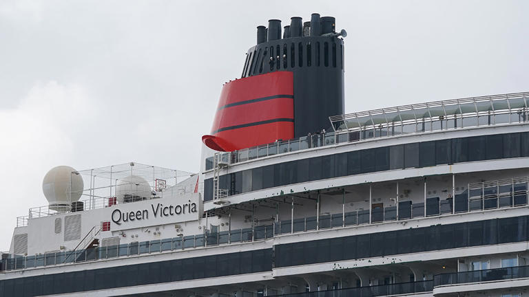 SOUTH SHIELDS, ENGLAND – APRIL 24: The MS Queen Victoria cruise ship sails from the Port of Tyne on April 24, 2022 in South Shields, England. The MS Queen Victoria cruise ship is operated by the Cunard Line and was moored at the Royal Quays Marina after returning from Barbados. The 90,049 tonne ship now heads to Southampton before beginning scheduled cruises next month. At 294 metres long and with the capacity for 2,061 passengers and 980 crew her facilities include seven restaurants, thirteen bars, three swimming pools, a ballroom, and a theatre. (Photo by Ian Forsyth/Getty Images)