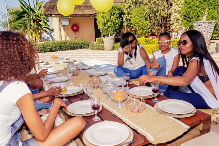 Here are 10 of the best bachelorette party destinations. Pictured: women gathered outside at a table.