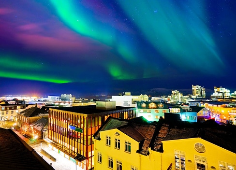 Spectacular views of the northern lights can be seen directly from the city center in Reykjavik, Iceland. <a>©JavenLin/ via Getty Images</a>