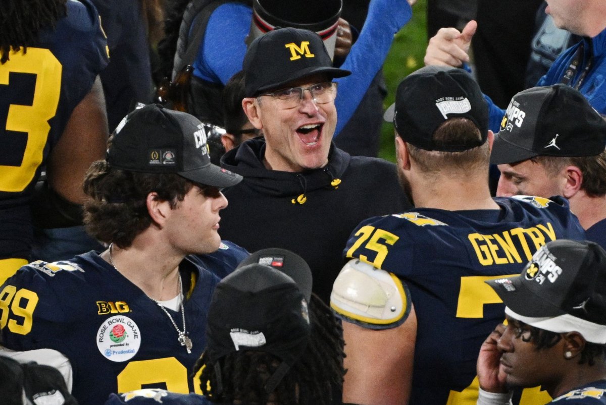 chargers hire michigan's jim harbaugh as new coach