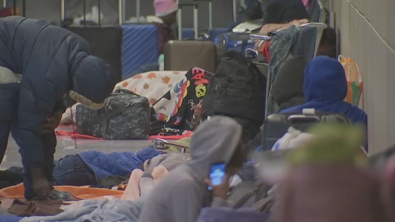 Migrants sleep at Logan airport amid calls for more aid