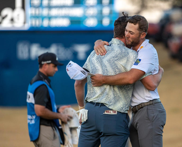 Sam Burns (right) embraces Nick Dunlap after Nick wins the final round of The American Express at PGA West in La Quinta, Calif., Sunday, Jan. 21, 2024.