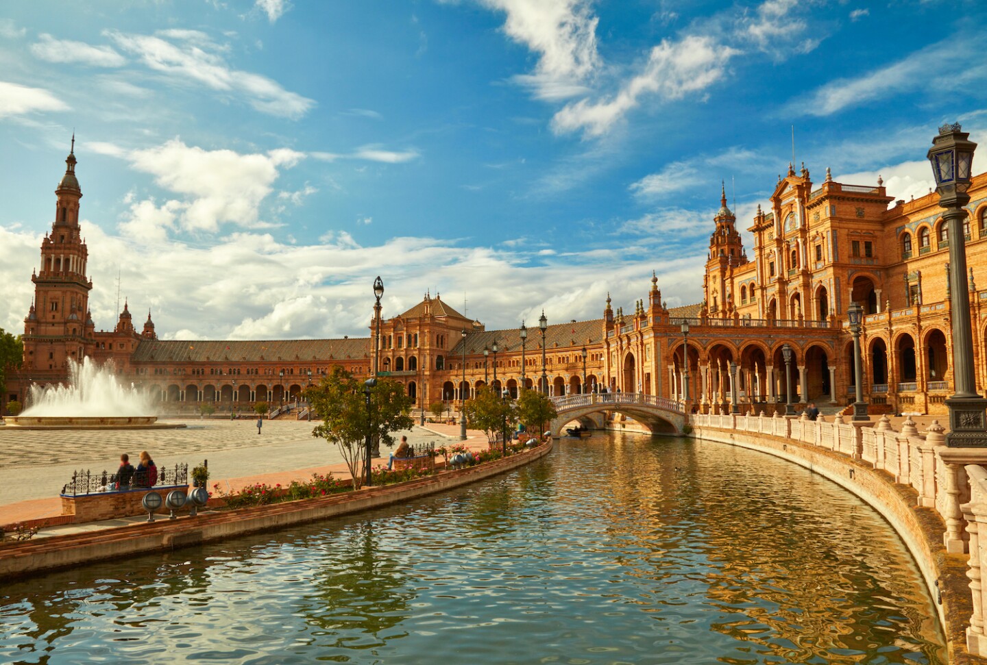 <h2>4. Seville</h2> <p><i>Andalusia</i></p> <p>Warm people, sunny days spent sipping sangria, and trees full of oranges—that relaxed, siesta-loving attitude of Spain is available in Seville. The capital of Spain’s Andalusia autonomous community still bears plenty of marks from its past under the Moors. One of the most beautiful places to explore its history is the Royal Alcázar of Seville, an 11th-century palace sporting walled gardens and geometric, patterned arches that have been <a class="Link" href="https://www.afar.com/magazine/game-of-thrones-destinations-you-can-visit-in-real-life" rel="noopener">featured in <i>Game of Thrones</i></a> and <i>Lawrence of Arabia</i>. Stop and smell the jasmine at Plaza de España, and walk along the curving wall featuring 52 colorful mosaics that depict all of Spain’s provinces.</p>