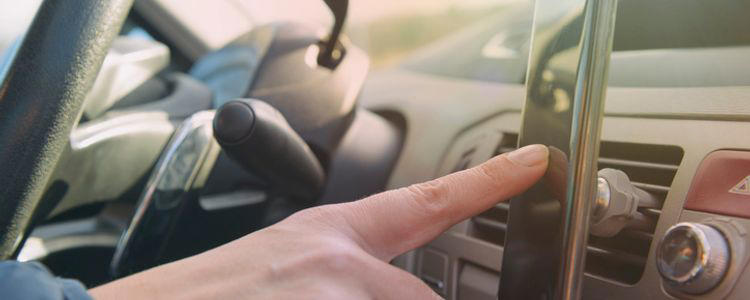woman opening GEICO mobile app before driving