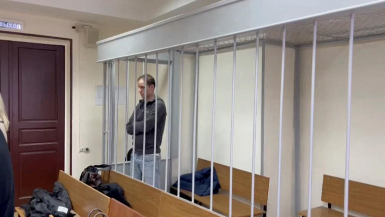 Wall Street Journal reporter Evan Gershkovich stands inside an enclosure for defendants during a court hearing in Moscow, Russia, January 26, 2024. (Moscow City Court's Press Office/Handout via Reuters)