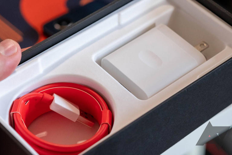 A OnePlus phone box with a charger inside.