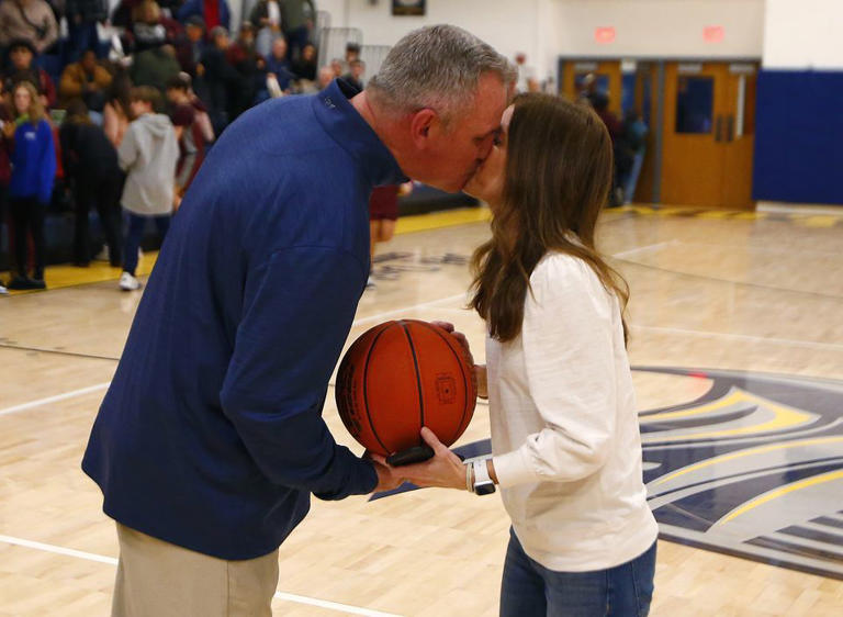 Notre Dame coach Pat Boyle kisses his wife Lisa after earning his 500th career victory with a win against Bangor on Jan. 26, 2024.