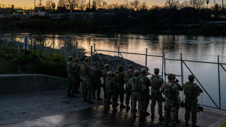 Texas National Guard soldiers stand guard on the banks of the Rio Grande at Shelby Park in Eagle Pass, Texas, on January 12. - Brandon Bell/Getty Images