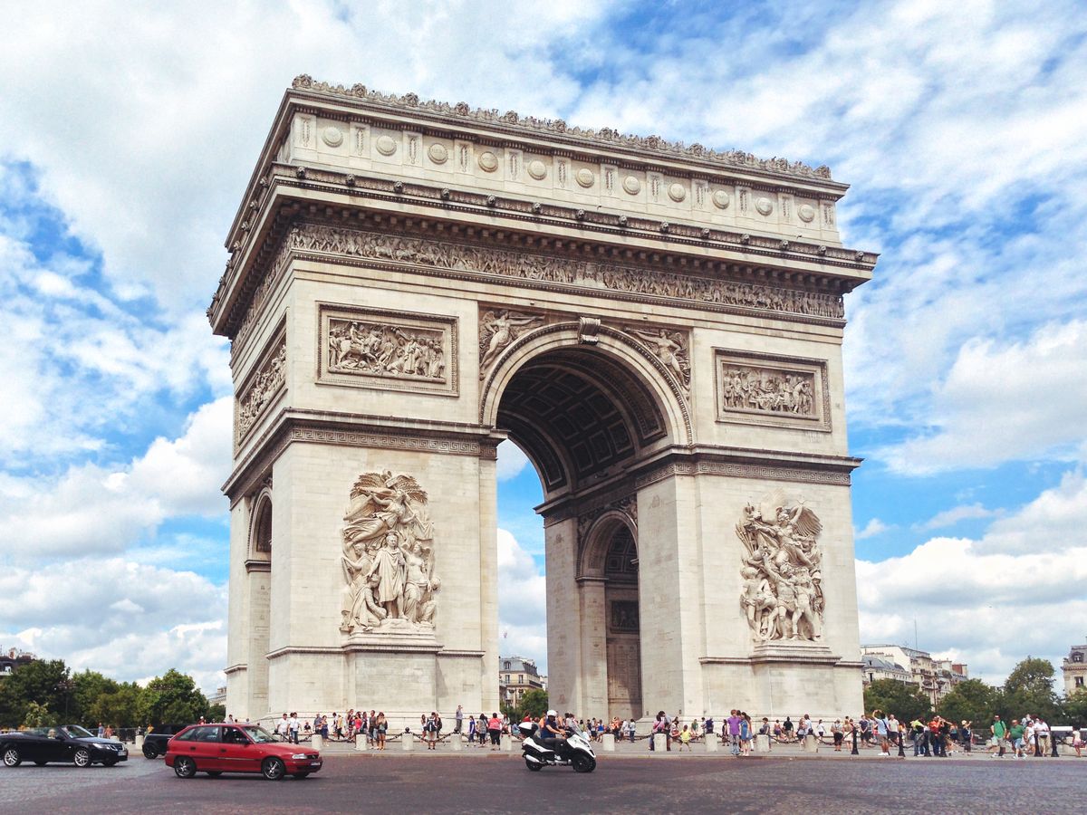 <p>Located at the western end of the Champs-Élysées at the center of a buzzy roundabout, the Arc de Triomphe was built to commemorate the French victory in the Battle of the Three Emperors, Napoleon's greatest military accomplishment. We recommend viewing this marvel from the backseat of a car to truly get the 360-,degree affect, but you can also climb stairs to the top for a special view of Paris.</p>