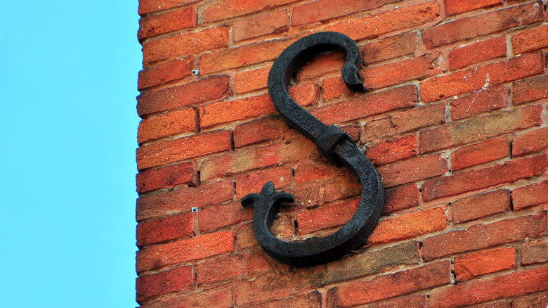 what it means to see those metal symbols on brick houses