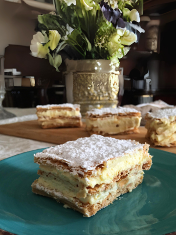 millefoglie with cream in a blue plate featured image