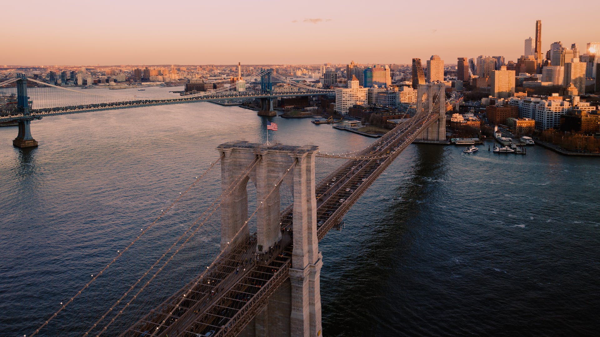 <p>The Brooklyn Bridge is a hybrid cable-stayed suspension bridge in New York City. It spans across the East River between Manhattan and Brooklyn, and supports 6 lanes of vehicles and a pedestrian/bike path.</p><p>It is known as the <strong>world’s first suspension bridge</strong>, and it was the longest when it opened in 1883.</p><p>Visitors report walking across the Brookyn Bridge at night to be a “magical experience”. The city skyline from the bridge is a view like no other.</p><p><strong>Features:</strong> Walking path</p><p>Lerone Pieters, Pexels</p>