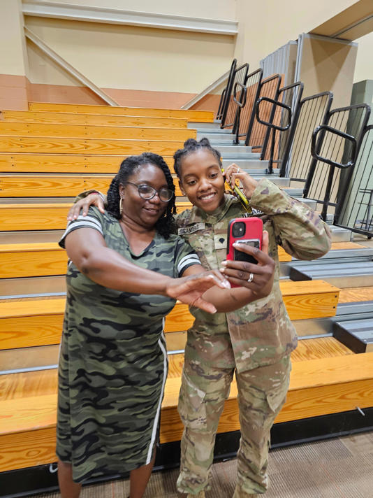 This undated image provided by Shawn Sanders shows Army Spc. Kennedy Sanders, right, posing for a selfie with her mother, Oneida Oliver-Sanders, at a ceremony in Columbus, Ga., on Aug. 9, 2023.