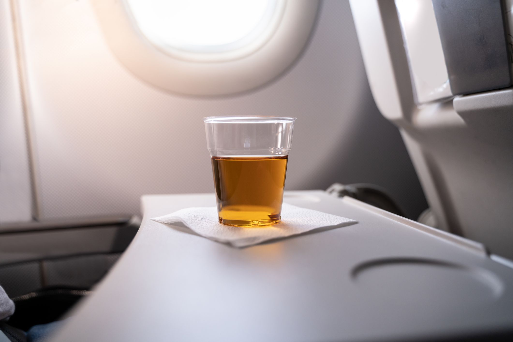 <p>Alcohol dehydrates you on the ground, and that effect is amplified when you're in a low humidity plane. Plus, the high altitude's affect on your blood oxygen can <a href="https://www.cntraveler.com/story/do-you-get-drunk-faster-on-a-plane#:~:text=Therefore%2C%20being%20at%20a%20higher,begin%20acting%20inebriated%20earlier%20than">make you feel tipsy faster than usual</a>. Both those things can lead to feeling pretty hungover when you're back on the ground, which is a terrible way to start a vacation. </p>