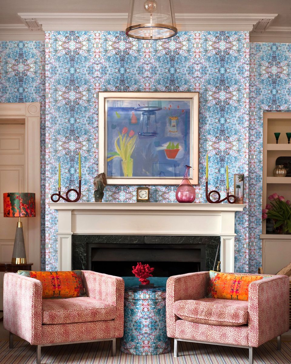 <p>Susi Bellamy is renowned for her intricate designs with mirrored patterns taken from her original artwork and marbled papers. It’s like looking through a kaleidoscope with all the different colours.</p><p>Because there are so many colours in it, it’s easy to pull out shades for furniture and accessories as she has here with red, orange and pink.</p><p>'This paper would work well for a feature wall or inglenook in a modern apartment or retro style home,' says <a href="https://www.susi-bellamy.com/">Susi Bellamy</a>, Wallpaper, Fabric and Accessory Designer. 'Perfect for dark corners to add some bold colour and pattern or behind a sideboard for some "modern art for the wall".'</p><p><em>Pictured: Pietra Blue mica non-woven wallpaper; Grey Stucco kaleidoscope oblong velvet cushions; matching velvet shade; Pietra Blu velvet storage stool, all <a href="https://www.susi-bellamy.com/">Susi Bellamy</a></em></p>