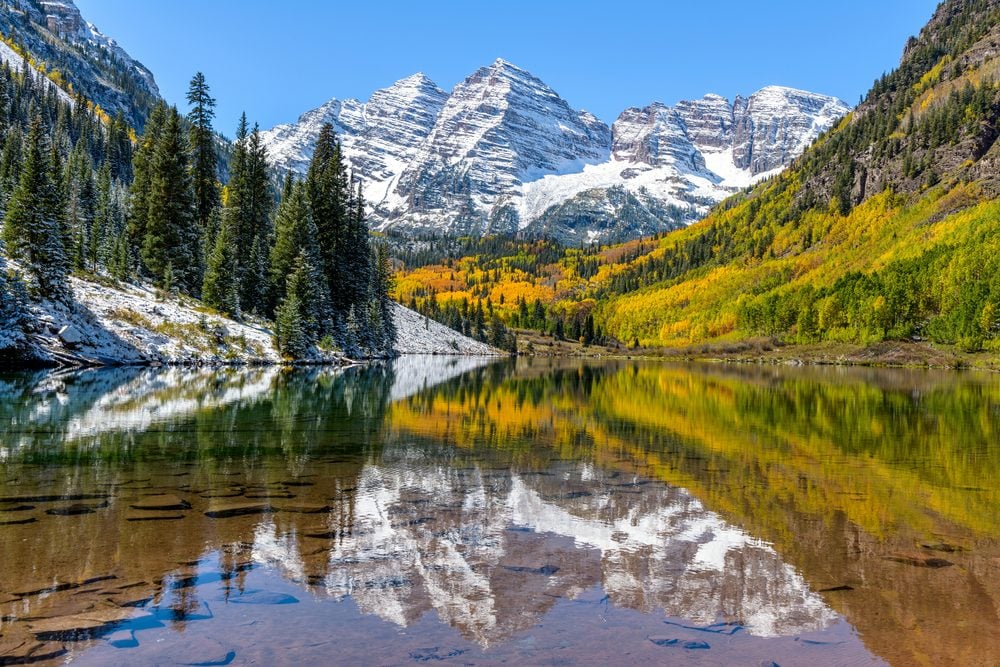 <p>Colorado is known for its bevy of natural beauty but <a class="SWhtmlLink" href="https://www.stayaspensnowmass.com/activities/visit-maroon-bells" rel="noopener noreferrer">Maroon Bells</a> definitely top the state's list of must-visits. In the glacier-formed valley at the foot of the towering twin peaks lies Maroon Lake lined by lush aspen trees. Sunny days provide the perfect panorama of the burgundy mountain caps and fluffy white clouds reflected in the shimmering water below. Don't miss these <a class="SWhtmlLink" href="https://www.rd.com/list/national-parks-full-bloom/">10 photos of America's National Parks in full bloom</a>.</p>