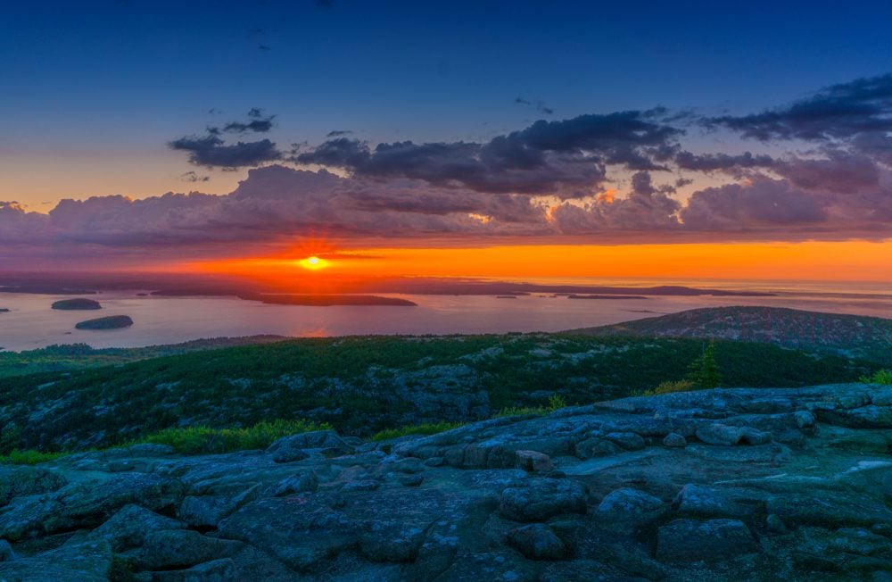 <p>This nature getaway is one for the early birds. <a class="SWhtmlLink" href="https://acadiamagic.com/CadillacMountain.html" rel="noopener noreferrer">Cadillac Mountain</a> in beautiful Acadia National Park is not only the highest point along the North Atlantic seaboard, but it's also the first place in the United States to see the sunrise. Head to the summit before dawn for a panoramic view of the sun coming up over the ocean in front of you and pink granite rock dotted with spruce trees and wild blueberry bushes all around you.</p>