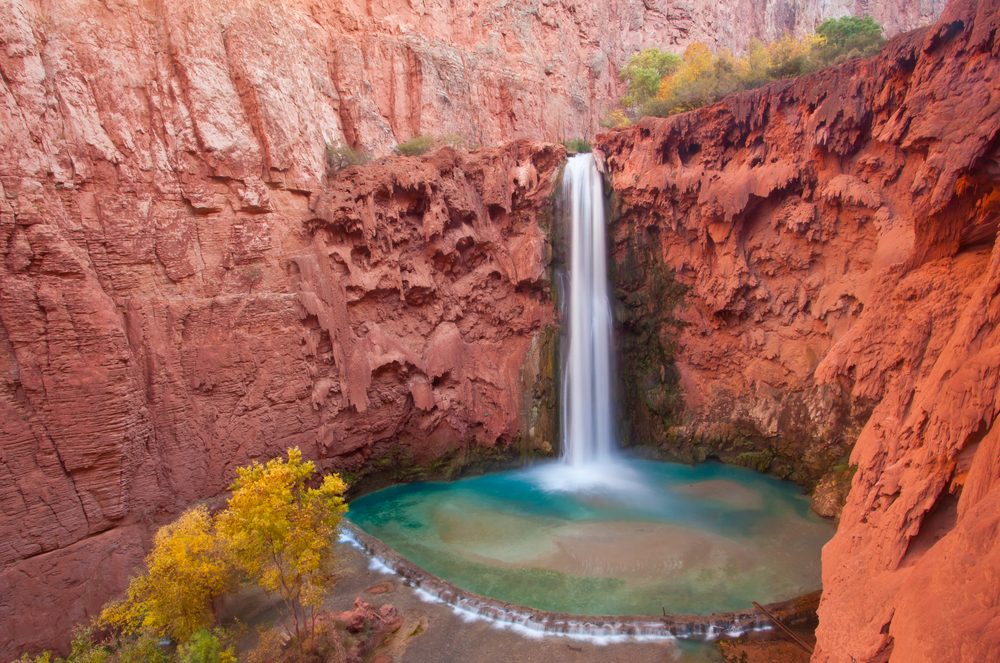 <p>If you're looking for an adventure outside of the Grand Canyon, head to its southern rim where you can hike through the Havasupai Reservation to Mooney Falls. It's not an easy trek (you have to scale a cliff face to get to the bottom) but the sight of the sparkling turquoise water against the red rocks of the canyon is so worth it. Here are more of <a class="SWhtmlLink" href="https://www.thehealthy.com/fitness/americas-hiking-trails/">America's most stunning hiking trails</a>.</p>