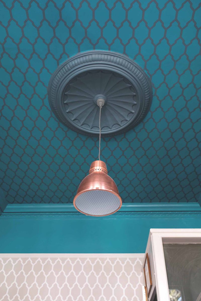 <p>Don't forget about the ceiling. It's often just painted white and forgotten about, but decorating the ceiling can make a huge difference to a living room. Complete the look with a complementary wallpaper as seen here, or use something completely different.</p><p><em>Pictured: Tessella BP3608 on the ceiling and BP3601 on the walls, both <a href="https://www.farrow-ball.com/wallpaper/tessella">Farrow & Ball</a></em></p>