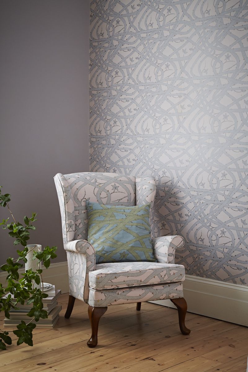 <p>This lovely Brambleweb wallpaper is used as a feature on one wall with a complementary paint shade on the other walls. To take the scheme one stage further, why not use fabric in the same design to cover an armchair?</p><p>'Living rooms are the obvious place for wallpaper, you can make a statement or add atmosphere. Paper the entire room and ceilings to envelop the space, Brambleweb wallpaper is perfect for this, the tangled vines appear to have been growing up the walls for years, like a modern day sleeping beauty,' says <a href="https://www.abigailedwards.com/">Abigail Edwards</a>, Wallpaper, Fabric and Accessory Designer.</p><p><em>Top Tip: </em>You could even add a cushion in the same fabric but a contrasting shade for a complete look.</p><p><em>Pictured: Brambleweb wallpaper in Nude, <a href="https://www.abigailedwards.com/shop/brambleweb-wallpaper-nude">Abigail Edwards</a></em></p>