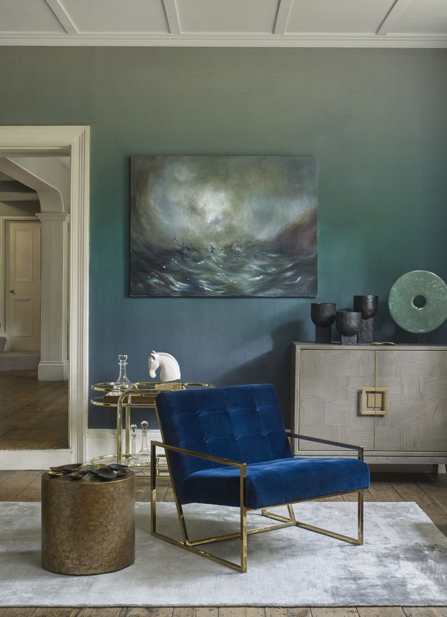 <p>A lovely way to add colour to a plain living room is with <a href="https://www.housebeautiful.com/uk/decorate/walls/how-to/a461/how-to-paint-an-ombre-wall/">ombre</a> wallpaper. Choose your favourite shade then have a wall that begins with a deep tone at the bottom and graduates to a paler shade at the top. It's subtle, calming, and easy to live with, especially in this lovely blue.</p><p><em>Pictured: Horizon Deep Blue wallpaper, <a href="https://elizabethockford.com/horizon/">Elizabeth Ockford</a></em></p>