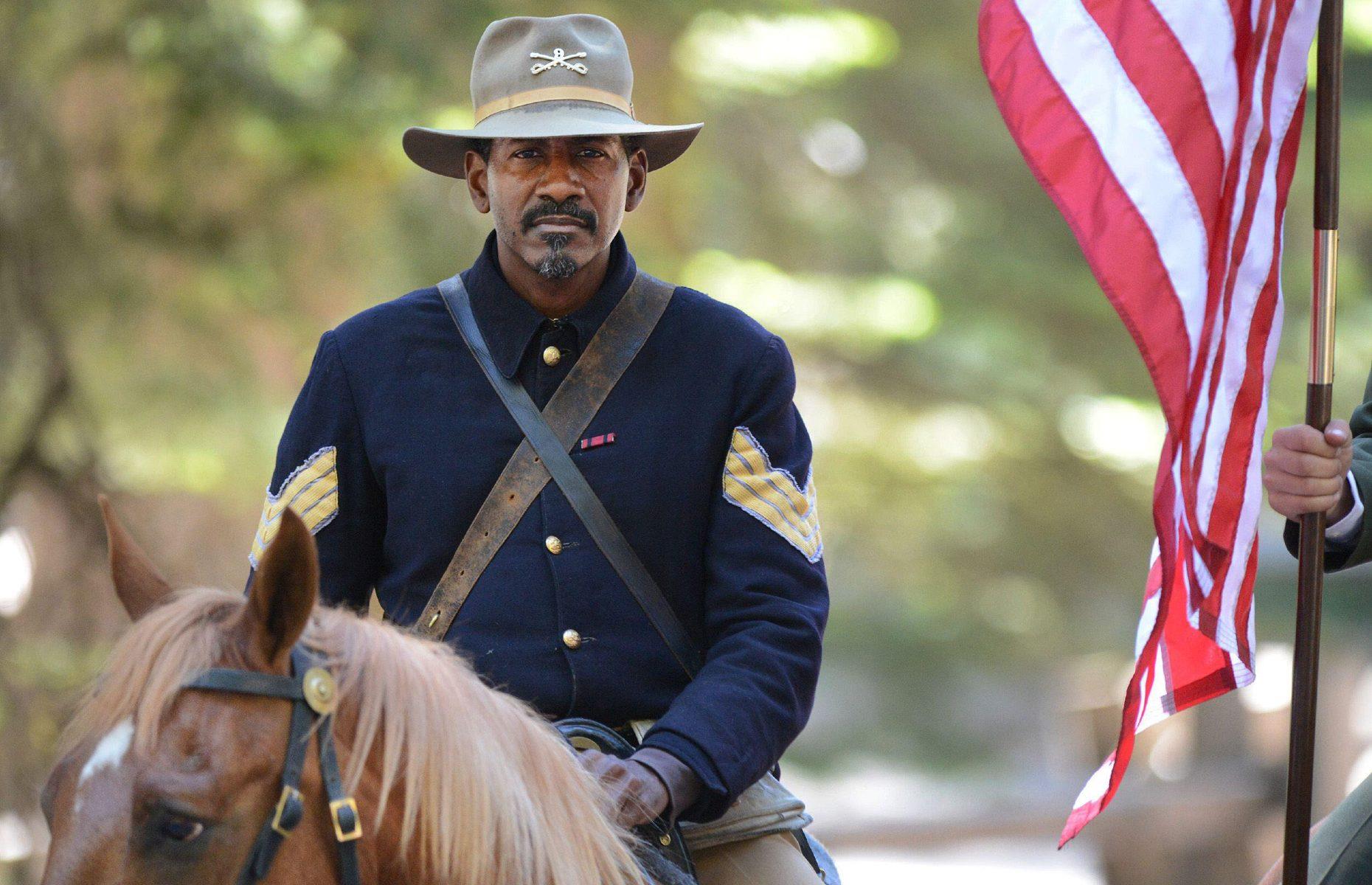 <p>Before the emergence of America’s National Park Service (NPS) in 1916, looking after Yosemite fell to the military, often to so-called buffalo soldiers. These men were African-American veterans of the Spanish-American War who, while serving overseas in rainy conditions, had learned to pinch their domed, wide-brimmed hats into symmetrical quadrants to keep water out of their faces. This 'Montana Peak' style continued when the soldiers began managing Yosemite, and was eventually incorporated into the official NPS ranger uniform. In this photo, Yosemite ranger Shelton Johnson wears the uniform of a buffalo soldier on the 150th anniversary of the Yosemite Grant.</p>