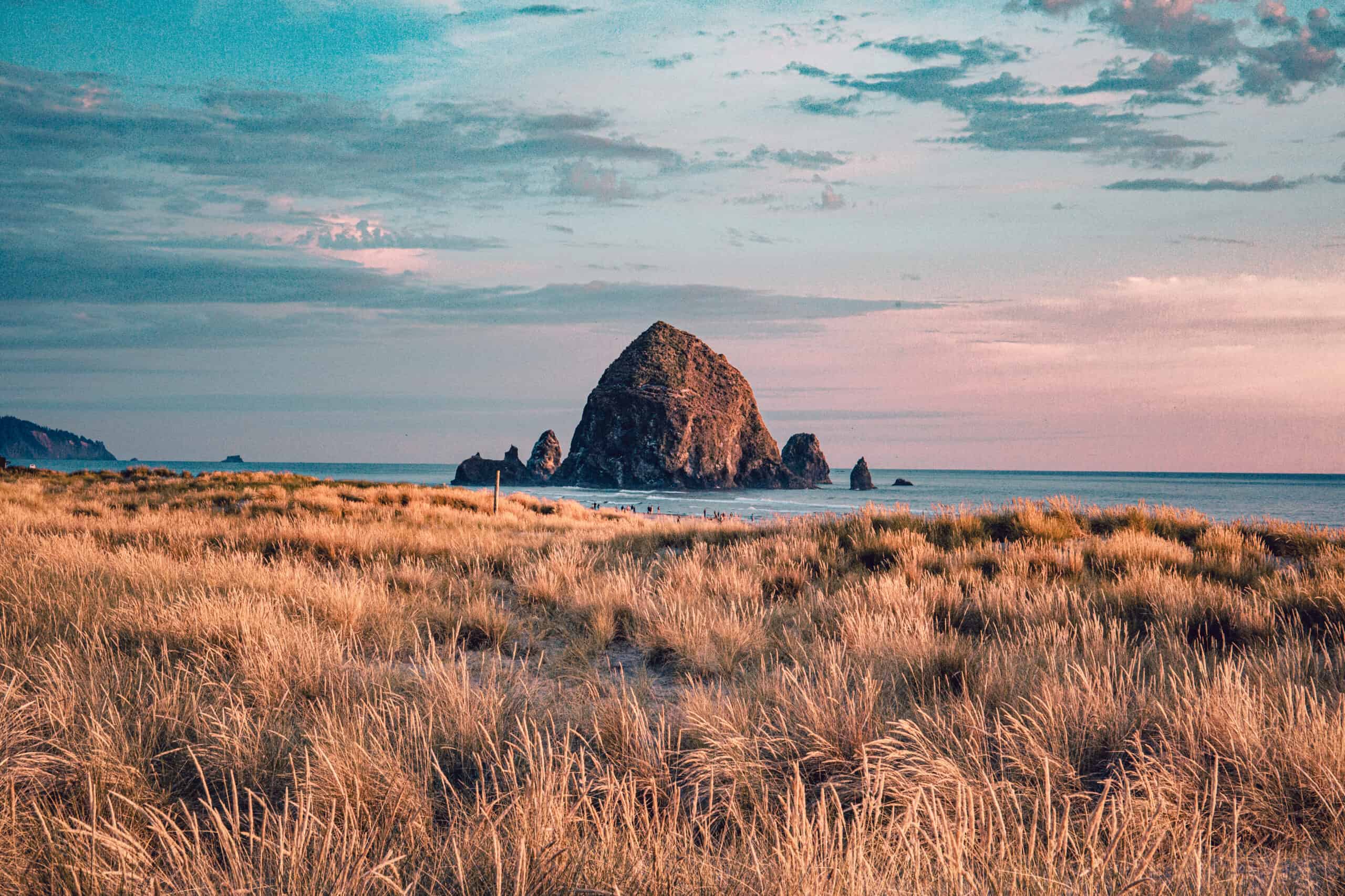 <p>You might recognize one of the most well-known landmarks on the Oregon coast, Haystack Rock near Cannon Beach, from the movie<em> The Goonies.</em> The basalt rock formation stands 235 feet tall and is part of the Oregon Islands National Wildlife Refuge. Visitors can explore the tidepools, and at low tide, you can walk out to Haystack Rock. The whole area is beautiful and teeming with wildlife like birds, sea lions, and crabs. During the Spring and Summer, you can see the tufted puffin birds, too. This is a great place where you can spend time outdoors on the historic Oregon coast.</p>