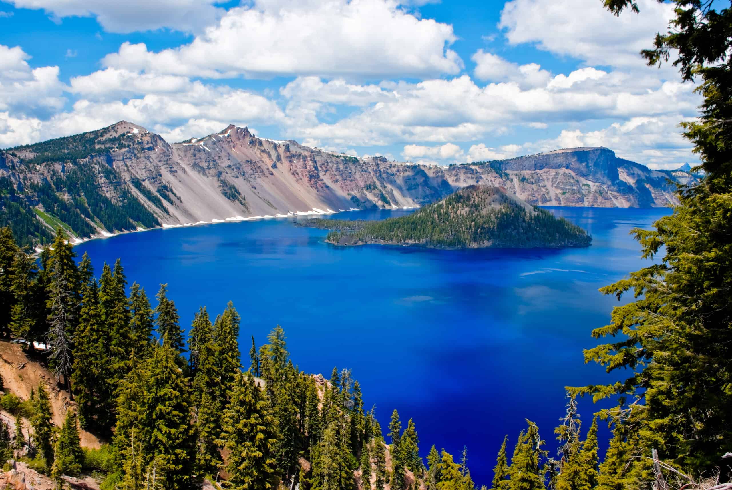 <p>Crater Lake is located in southeastern Oregon, and it is a volcanic crater lake created by the eruption of Mount Mazama 7,700 years ago. The first thing you will notice about Crater Lake is the deep blue color of the water. Crater Lake is one of the things Oregon is known for because it is the deepest lake in the United States and in the top ten of the deepest lakes in the entire world. Visitors come to the lake to enjoy the surrounding recreation area, where you can hike, mountain bike, and fish between June and September. There is lodging at the lake and boat excursions to go out and look at the two island formations in the middle of the lake. Swimmers may be disappointed because the lake is extremely cold, and swimming is only permitted in two areas.</p>