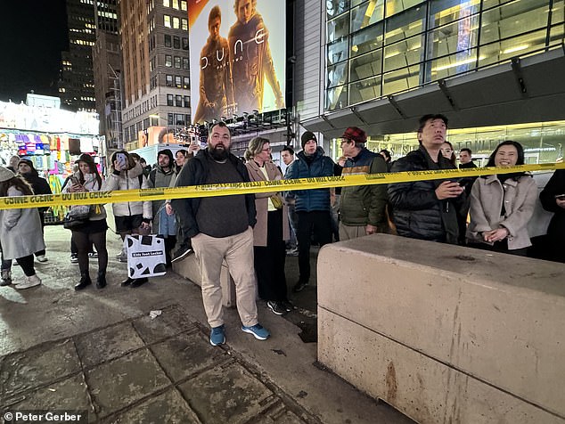 shoplifters open fire on security guard in new york city's busy times square hitting an innocent bystander in the leg and sending tourists fleeing for cover