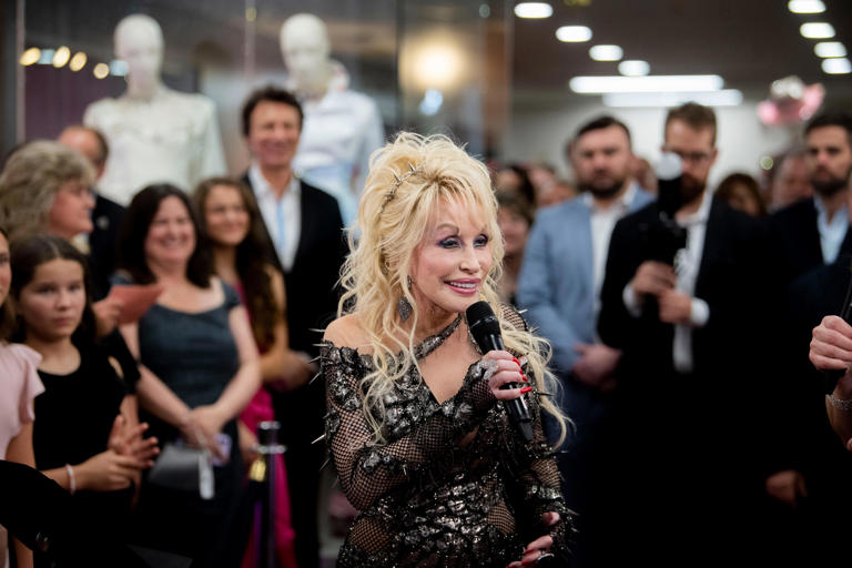 Dolly Parton speaks to the crowd during the opening of the Dolly Parton & The Makers: My Life In Rhinestones fashion exhibition at Lipscomb University in Nashville on Oct. 27, 2023.