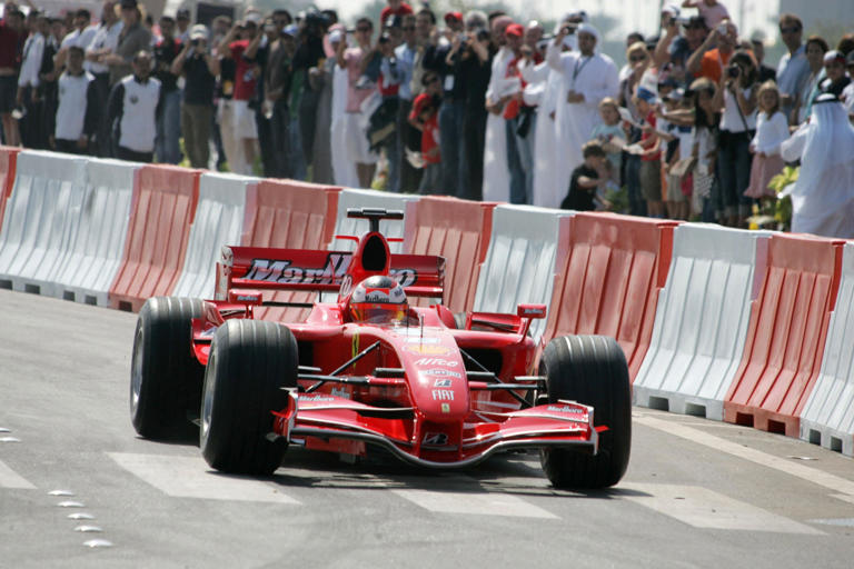 Kimi Raikkonen drives his Ferrari in Abu Dhabi in 2007 to celebrate the announcement of the first grand prix in the capital. AFP