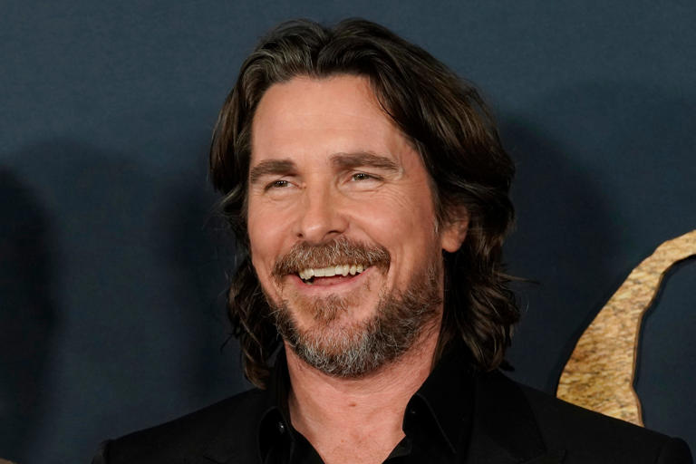 Christian Bale and cast members in "The Pale Blue Eye," share a laugh at the premiere of the film, Wednesday, Dec. 14, 2022, at the Directors Guild of America in Los Angeles. Bale has broken ground Wednesday, Feb. 7, 2024, on a project he’s been pursuing for 16 years -- the building of a dozen homes and a community center intended to keep siblings in foster care together. (AP Photo/Chris Pizzello, File)